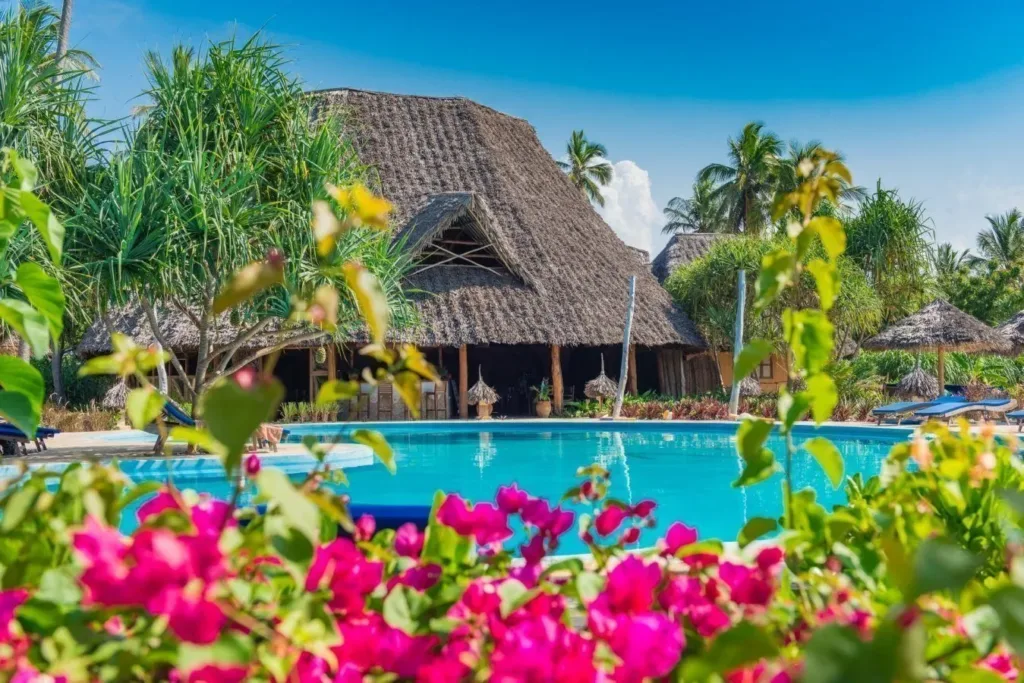 Serene private beach with turquoise waters in front of Zanzibar Queen Hotel.