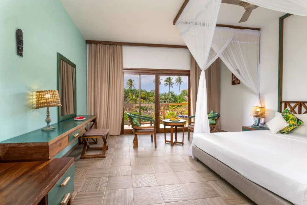 Elegant and cozy hotel room with ocean-themed decor at Zanzibar Queen Hotel.